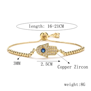 Detail view of gold Hamsa Hand bracelet with blue zircon inlay and bead measurements