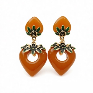 Vintage resin heart drop earrings with amber tone and green enamel leaf design