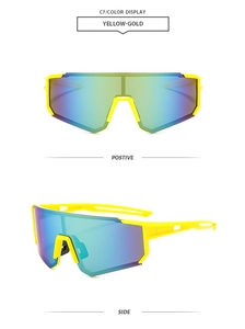 Detail view of yellow-gold frameless cycling sunglasses with colorful coated lenses