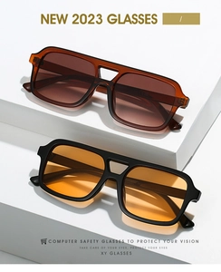 Detail of square sunglasses with double bridge frames in black and brown colors