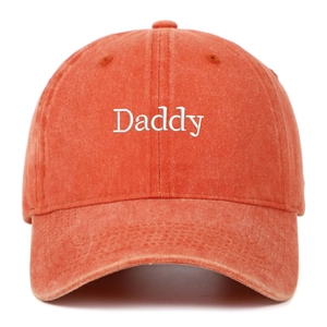 Close-up of white Daddy embroidery on vintage washed cotton orange baseball cap