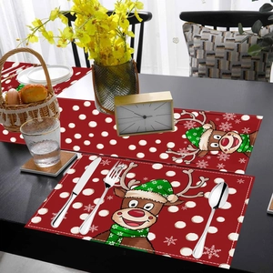 Detailed view of Christmas table runner with red cartoon reindeer and white polka dots