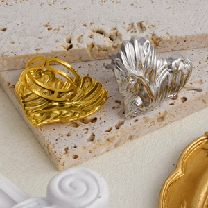 Detail of gold and silver heart rings with wrinkled texture and adjustable open bands