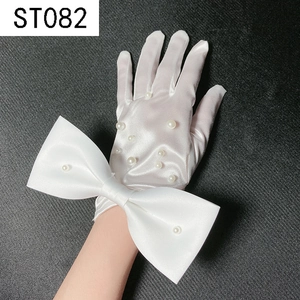 Close-up of white satin bridal glove featuring pearl embellishments and a large bow