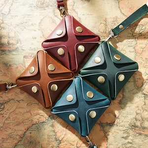 Minimalist leather coin purses in four colors with snaps on a vintage map background