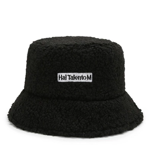 Chic black lambswool bucket hat with embroidered square label for winter warmth