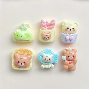 Macro view of six cute miniature resin bear and frog food charms in soft pastel colors