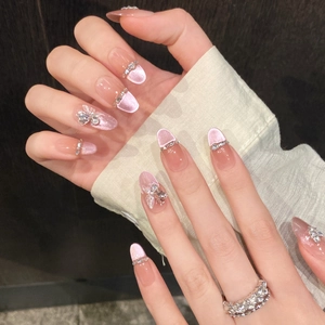 Handmade pink cat-eye press-on nails with 3D butterfly charms and gradient blush finish