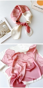 Detail of pink and white floral silk scarf showing satin texture and elegant print