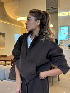 Detail of a brown half-zip hoodie set featuring premium textured knit fabric