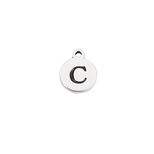 Close-up of polished stainless steel round charm with black engraved letter C detail