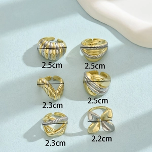 Set of 6 two-tone adjustable rings with spiral, layered, and butterfly designs