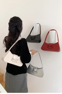 Chic baguette bags with decorative bows in cream white, silver, black, and vibrant red