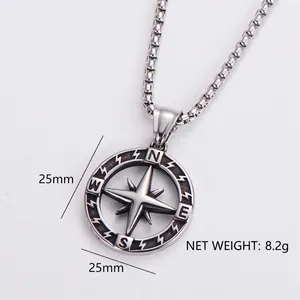 Detail view of silver compass pendant necklace with N E S W engraving and 25mm diameter