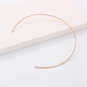 Minimalist rose gold stainless steel open choker necklace displayed on a white stone base