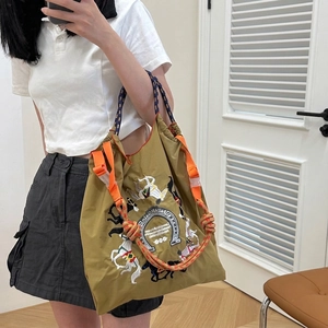 Mustard yellow equestrian tote bag with horse embroidery and braided rope handles