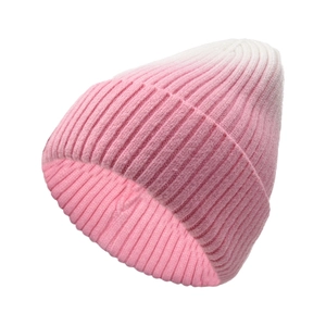 Detailed close-up of pink and white gradient knitted beanie with vertical ribbed texture