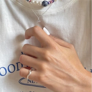 Minimalist 925 sterling silver wavy ring styled with layered rainbow pendant necklaces