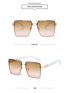 Close-up of oversized square sunglasses featuring gold metal bridge and gradient brown pink lenses