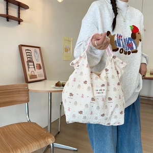 Detailed view of white cartoon rabbit canvas tote bag with textured puckered fabric