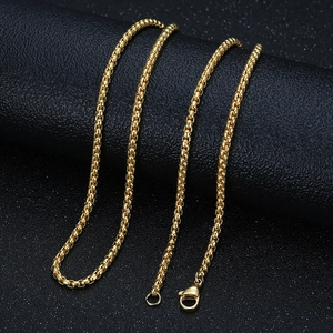 Elegant gold square box chain necklace in titanium steel on a black textured background