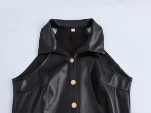 Detail of black leather halter dress featuring gold buttons and collar texture