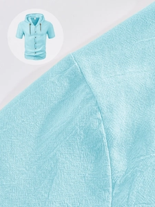 Detailed macro view of breathable sky blue linen-cotton fabric on a hooded shirt