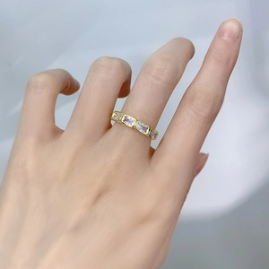 Elegant gold ring with rectangular white zircon stones shown on a model hand