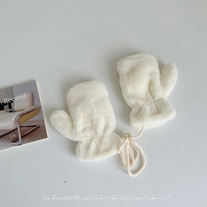 Close-up of white plush winter mittens for children with a soft neck string and thick fleece