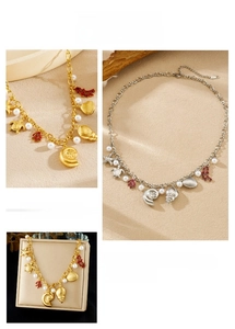 Close-up of ocean-themed necklace with starfish, coral, shell charms and pearls