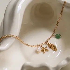 Golden ocean series necklace with starfish seashell pendants and green gemstone bead