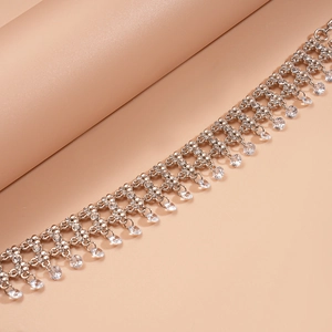 Detailed macro view of silver tassel necklace with shimmering teardrop cubic zirconia
