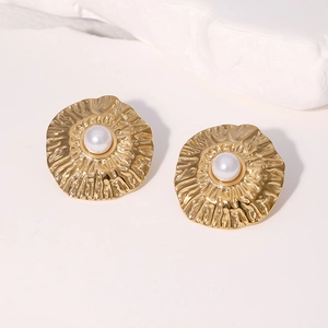 18K gold-plated irregular textured earrings with central white pearl on stone background