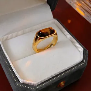 Vintage chunky gold ring with rectangular tiger eye stone on luxury velvet display