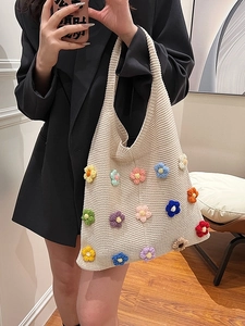 Chic off-white knitted tote bag with colorful 3D crochet flowers in a boho style