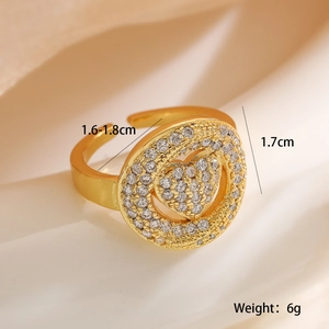 Luxurious gold heart ring with pavé cubic zirconia set on beige pleated satin