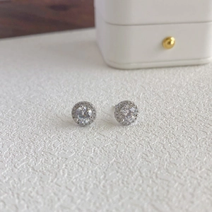 Detailed close-up of S925 silver stud earrings with a sparkling round zircon halo design