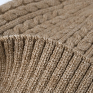 Thick cable knit winter beanie with ear protection in khaki fleece-lined fabric