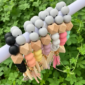 Close-up of food-grade silicone beaded keychain with marble patterns and leather tassels