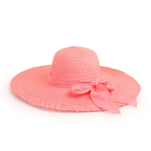 Close-up of pink straw hat featuring fine weaving and a delicate satin ribbon bow