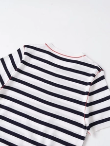 Close-up of black and white striped knit top featuring contrast red stitching on the neckline