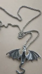 Detailed silver dragon pendant necklace featuring an intricate flying dragon sculpture