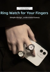 Detail of silver alloy ring watches with white dials worn on fingers for a stylish look