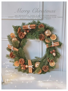 Close-up of artificial Christmas wreath with pine cones, cinnamon sticks, and orange slices