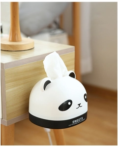 Detail of panda-shaped wall-mounted plastic tissue box fixed on wooden furniture side