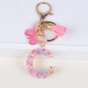 Glitter resin initial C keychain with pink butterfly pendant and tassel accessory