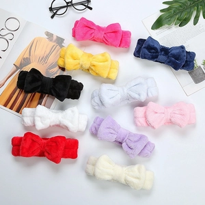 Flat lay of colorful coral fleece bow headbands in ten assorted pastel and bold colors