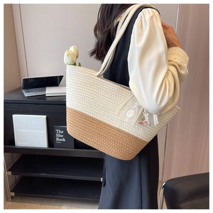 Detail of woven tote bag with floral embroidery and white lace trim on beige cotton rope