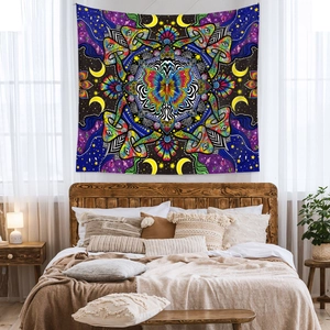 Bohemian mandala tapestry with butterfly, mushroom, and moon patterns in a cozy bedroom