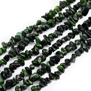 Macro view of irregular natural green and black turquoise stone beads for DIY jewelry